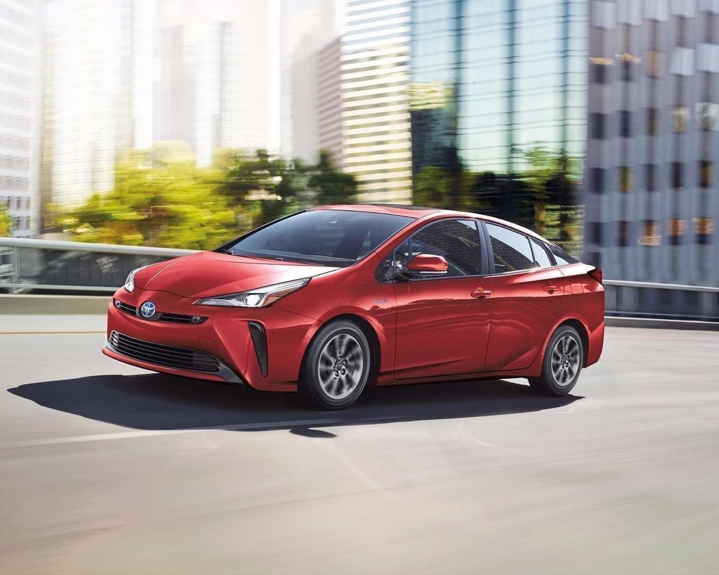 Red 2022 Toyota Prius hybrid for urban driving, a reliable and economical used car.